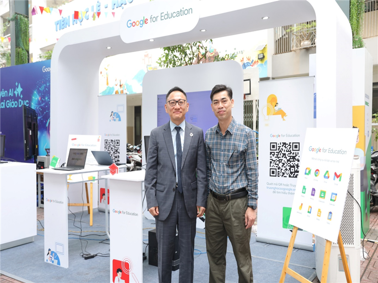 Two men standing in front of a display

Description automatically generated